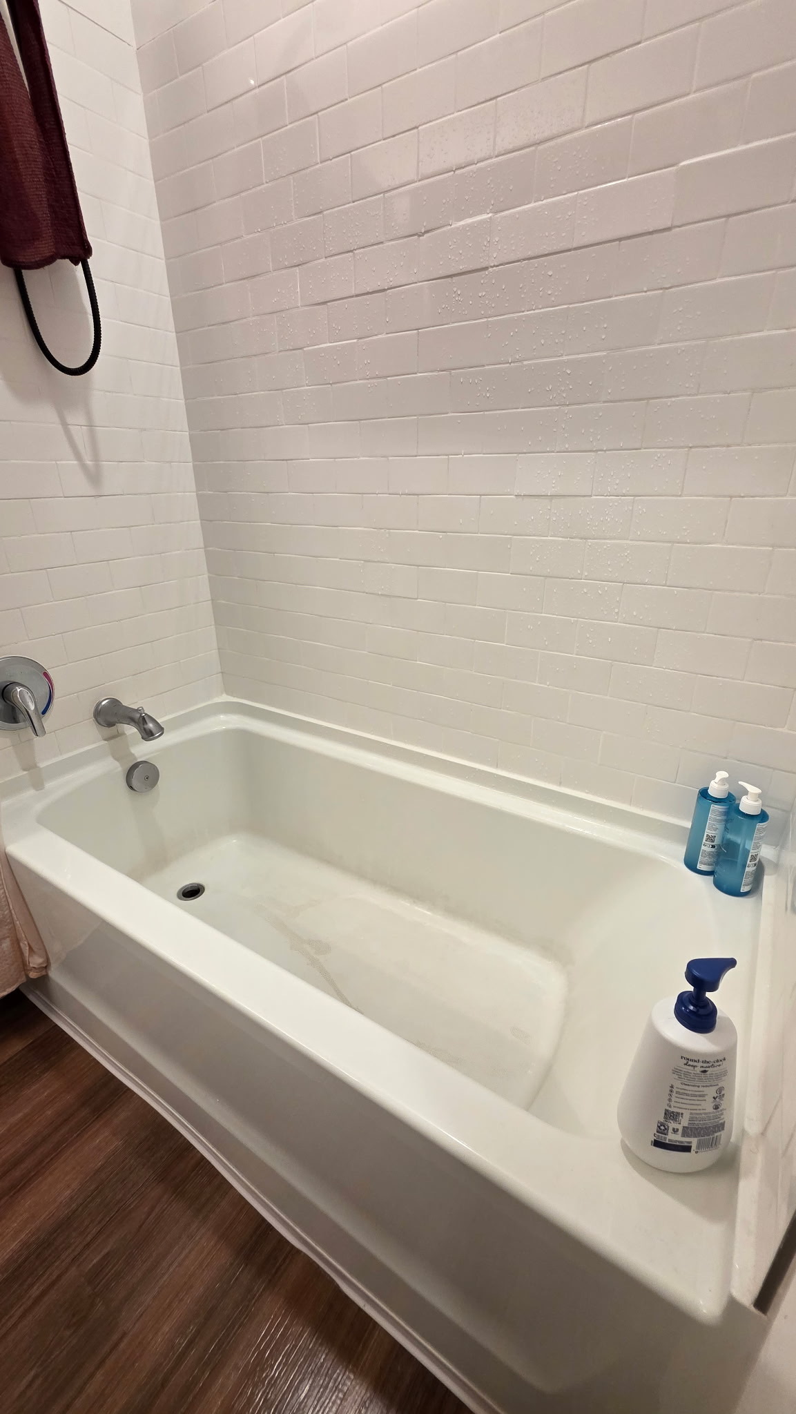 Bathroom tub and shower before cleaning, with visible buildup